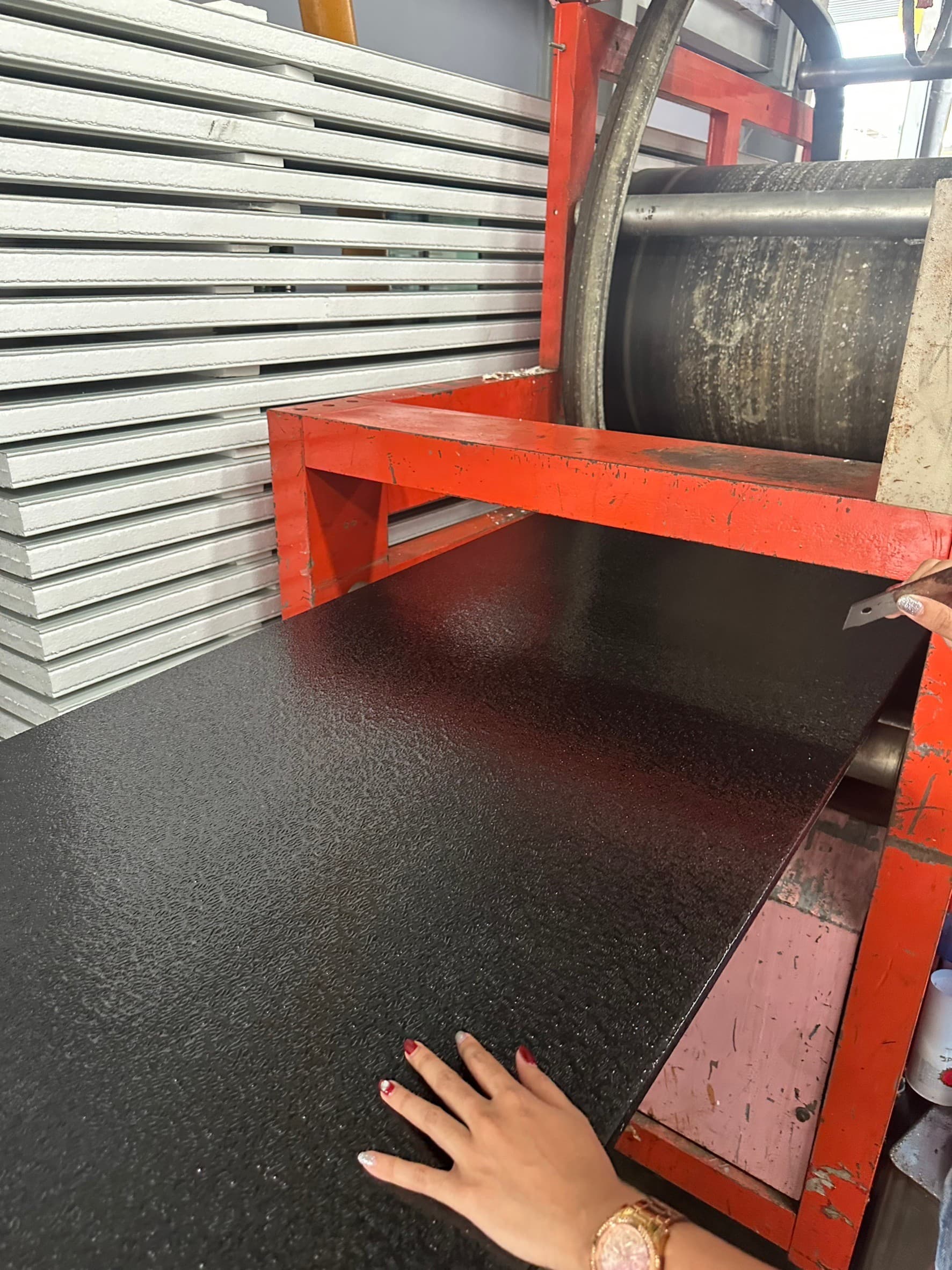 Black textured panel facing beside a stack of white panels