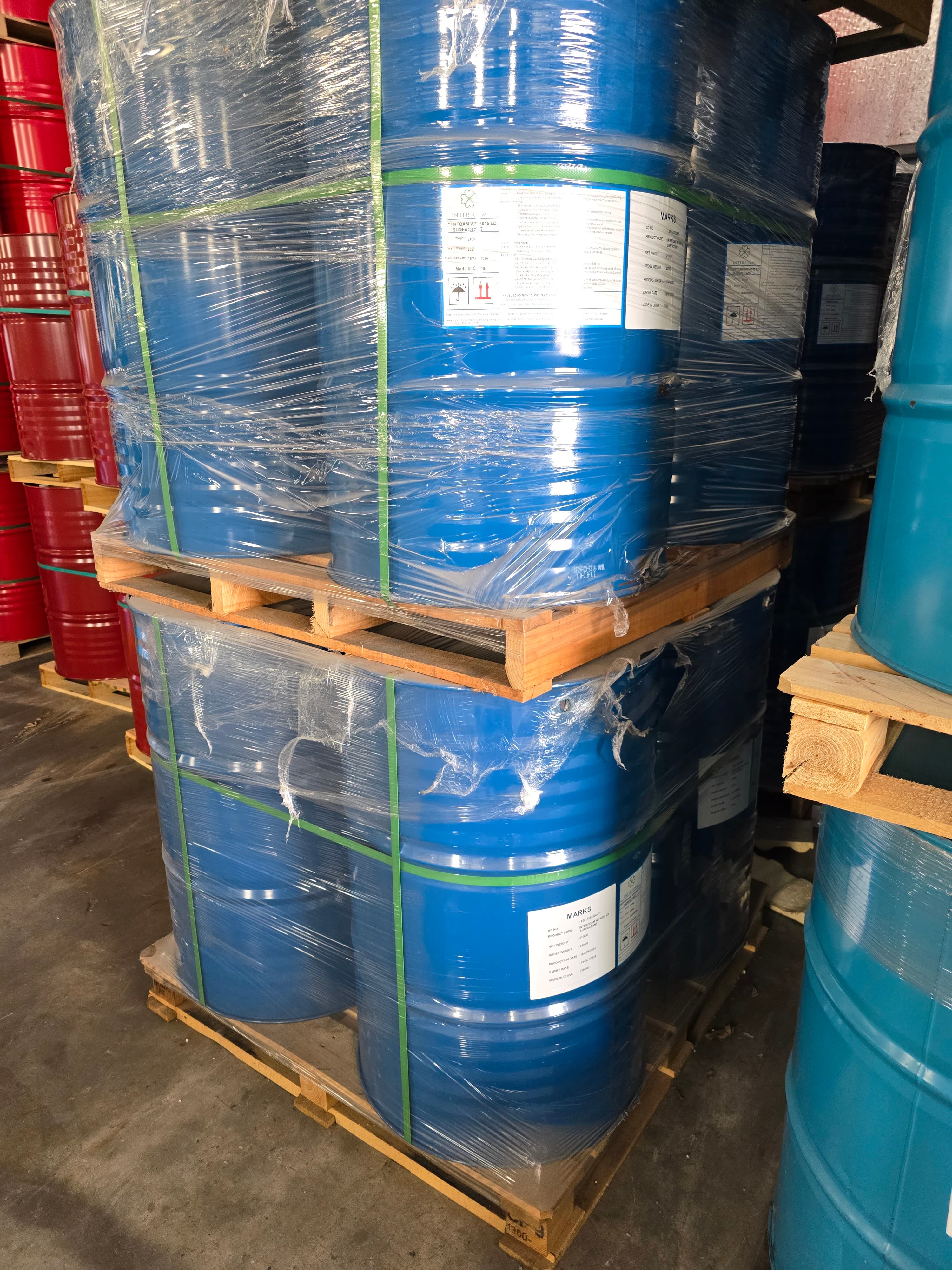 Polyol drums wrapped on pallets in a warehouse