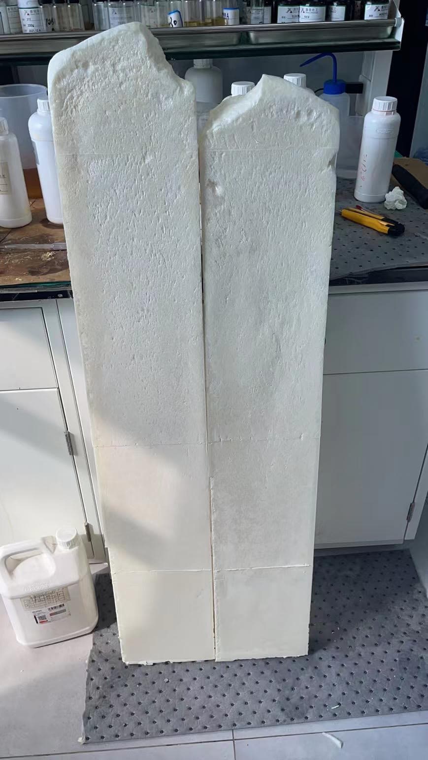 Two cured white polyurethane foam blocks