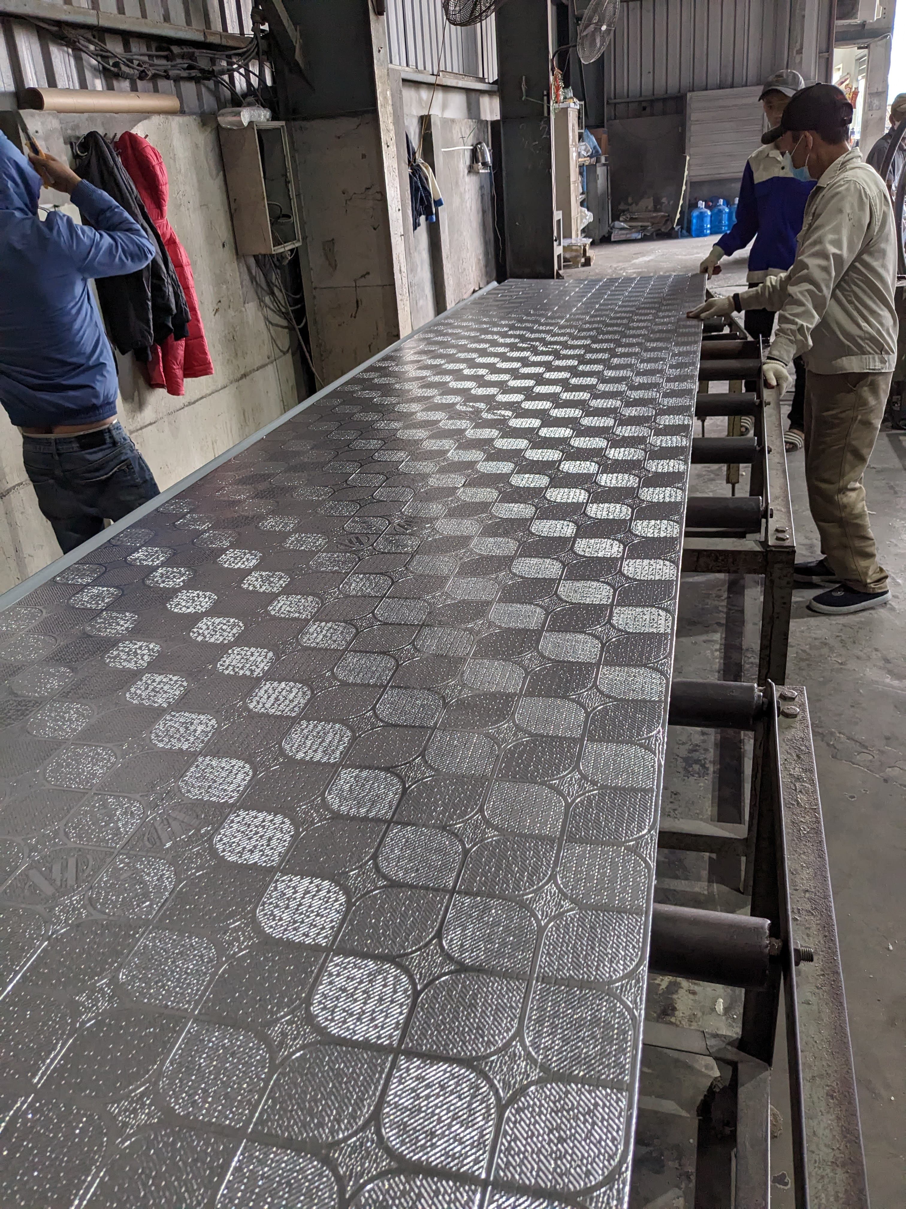 Embossed panel moving along a roller line